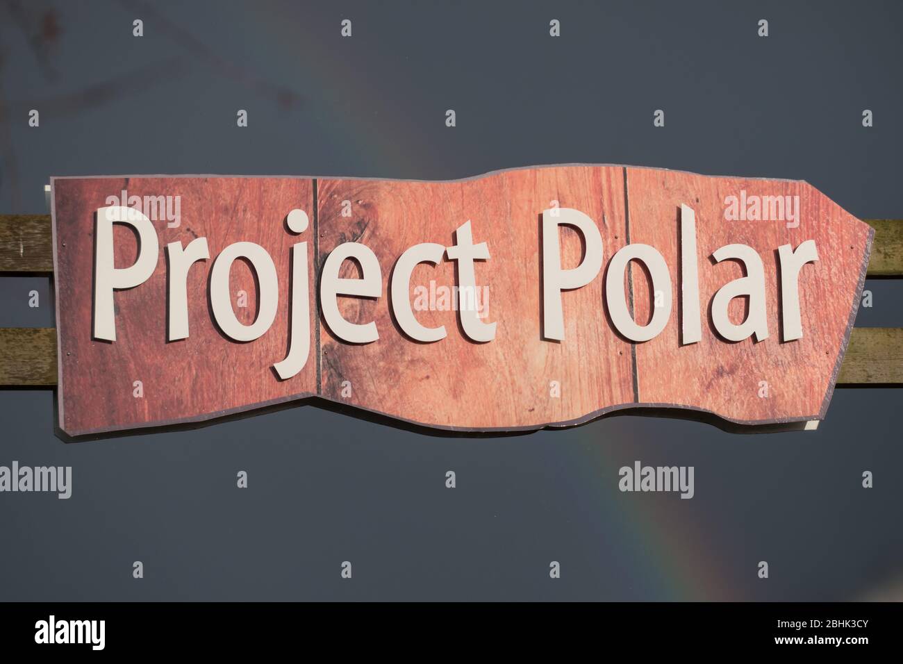 Sign for Project Polar at the Yorkshire Wildlife Park in winter with a rainbow behind Stock Photo