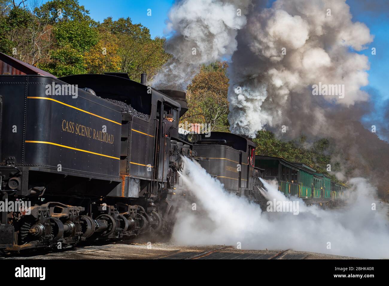 The large steam engine at Cass Scenic Railroad State Park in West Virginia releases large plumes of steam into the air before taking off from the stat Stock Photo