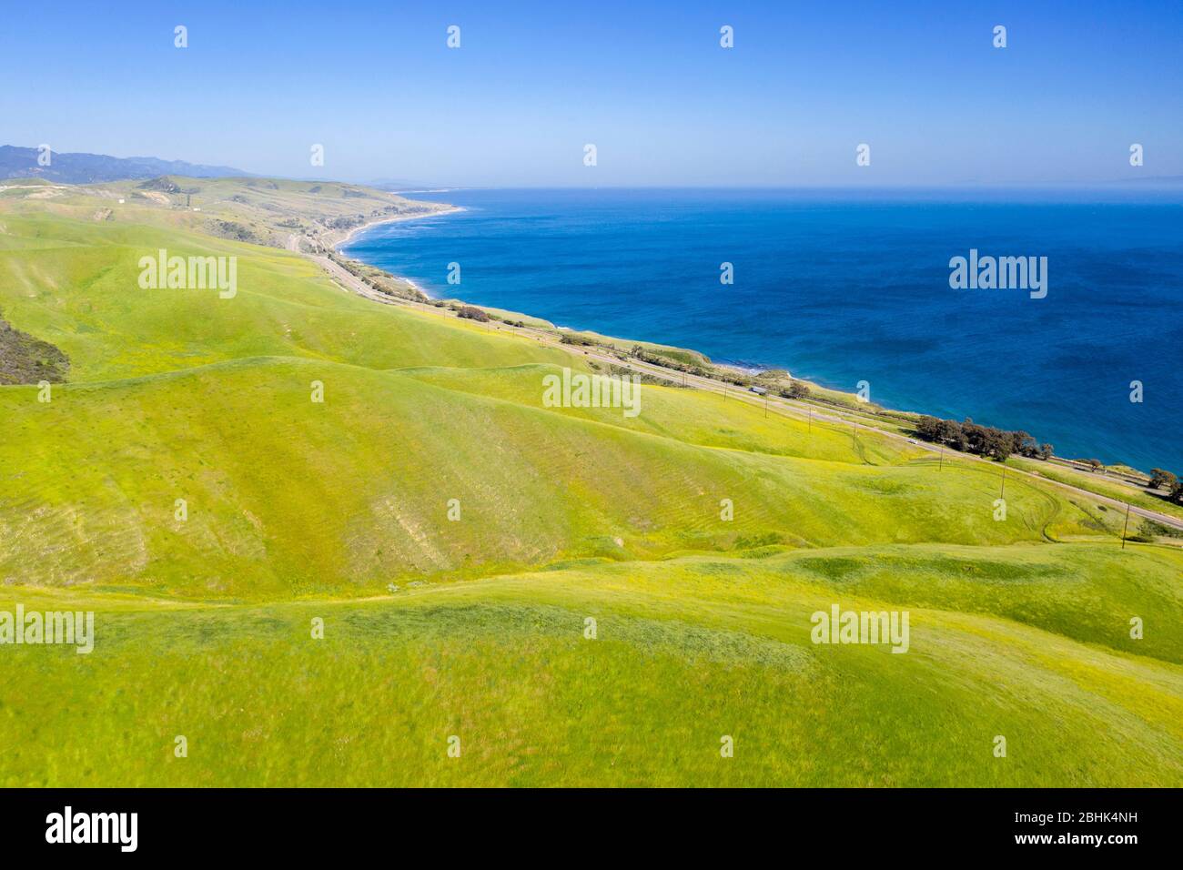 Aerial view above the green hills and blue Pacific in beautiful coastal