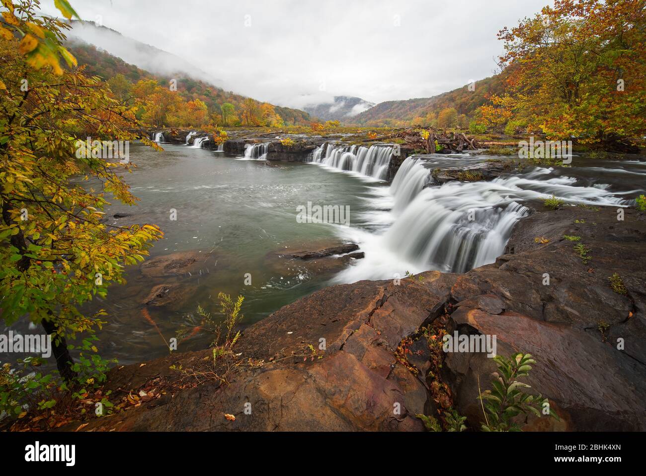A foggy morning view at Sandstone Falls in autumn on the New River in West Virginia. Stock Photo
