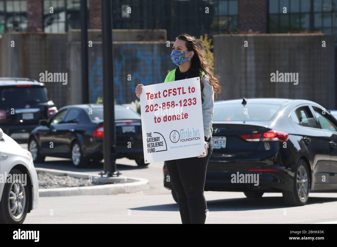 St. Louis, United States. 26th Apr, 2020. A volunteer holds a sign as hundreds line up in their cars to receive free food, in St. Louis on Sunday, April 26, 2020. Hundreds of cars lined the streets for an opportunity to receive food from several restaurants, while the group took donations for theThe Gateway Resilience Fund, an organization that assists fellow restaurant workers that are out of work because of the coronavirus. Photo by Bill Greenblatt/UPI Credit: UPI/Alamy Live News Stock Photo
