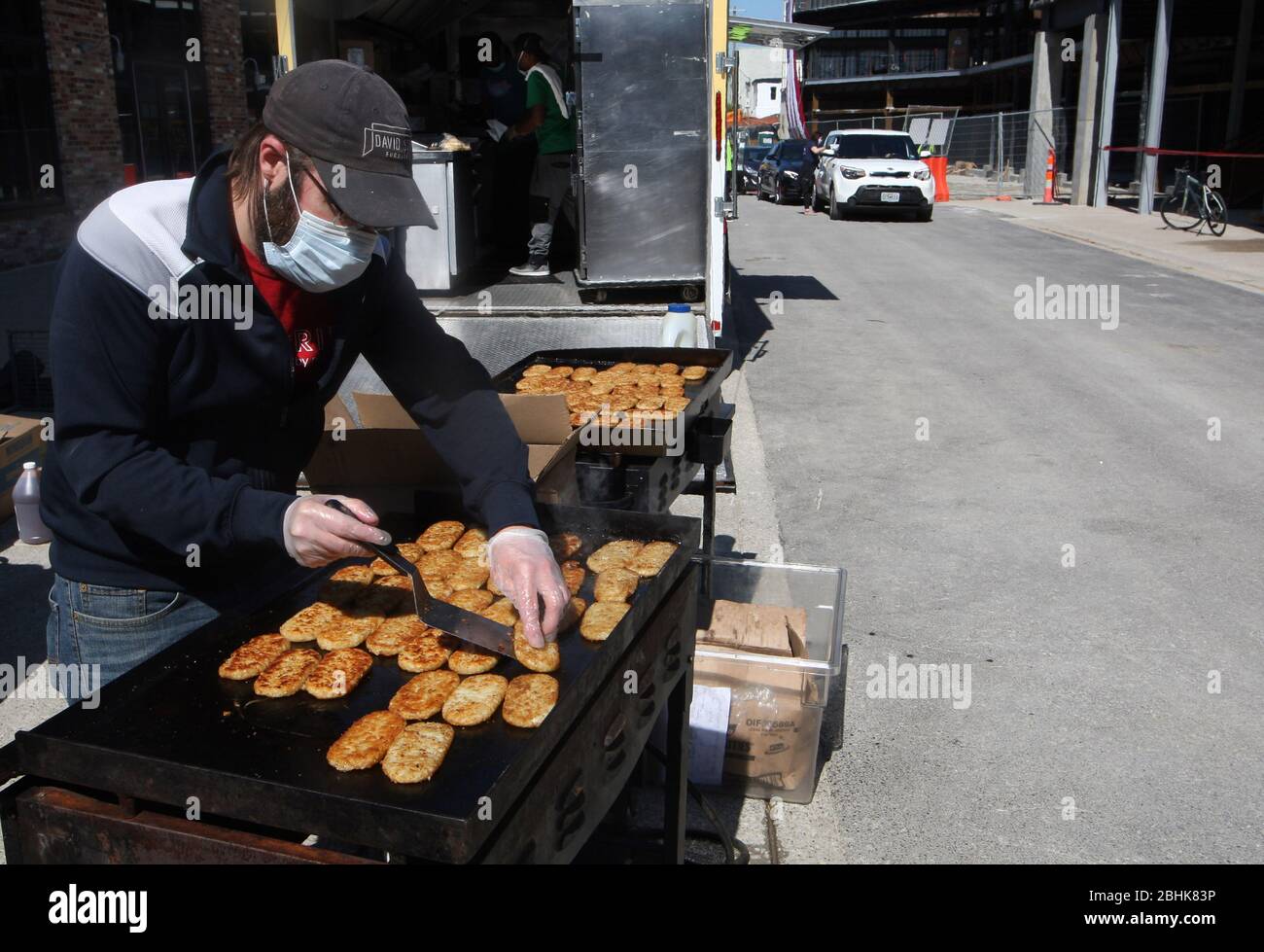 St. Louis, United States. 26th Apr, 2020. A volunteer cooks hash brown as cars wait for prepared sandwiches, in St. Louis on Sunday, April 26, 2020. Hundreds of cars lined the streets for an opportunity to receive food from several restaurants, while the group took donations for theThe Gateway Resilience Fund, an organization that assists fellow restaurant workers that are out of work because of the coronavirus. Photo by Bill Greenblatt/UPI Credit: UPI/Alamy Live News Stock Photo