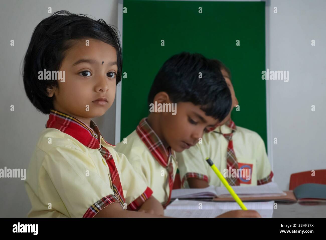 young school student studying in classroom Stock Photo