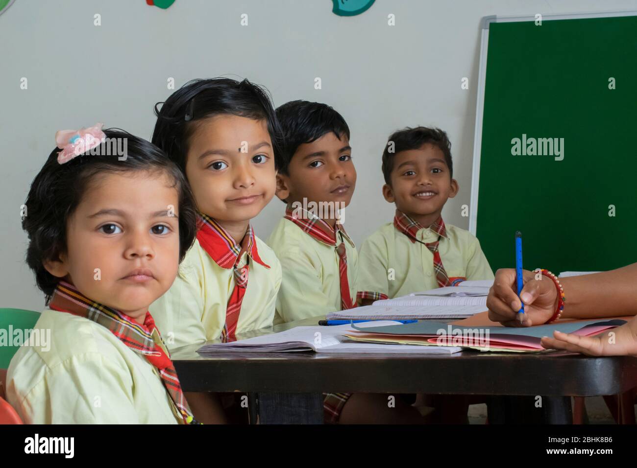 Young primary or elementary school children sitting at their desks in a classroom Stock Photo