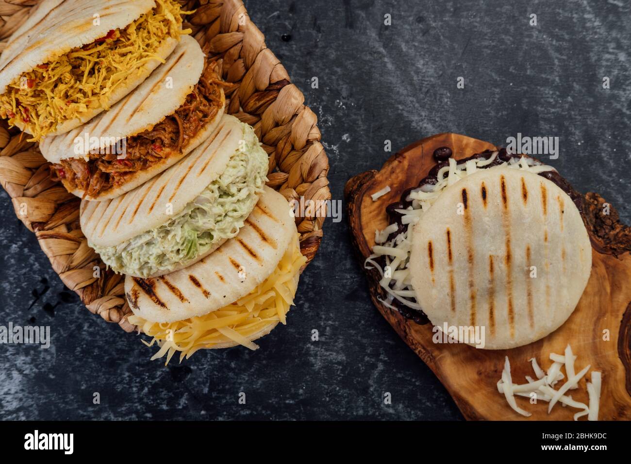 Top view of various types of typical Venezuelan arepas in a woven basket Stock Photo