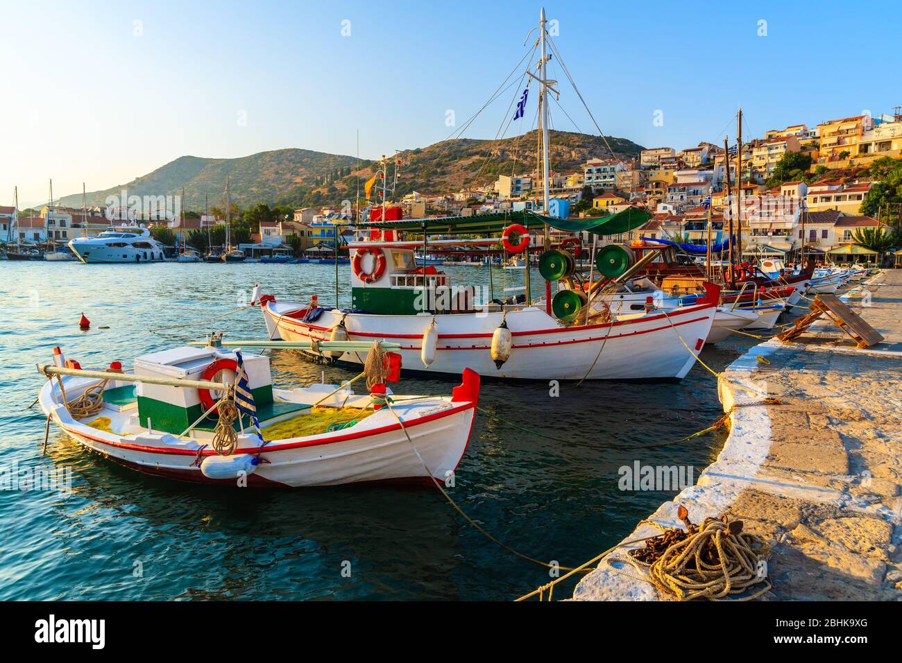 SAMOS ISLAND, GREECE - SEP 18, 2015: Beautiful traditional fishing boats in Pythagorion port at sunset time, Samos island, Greece. Stock Photo