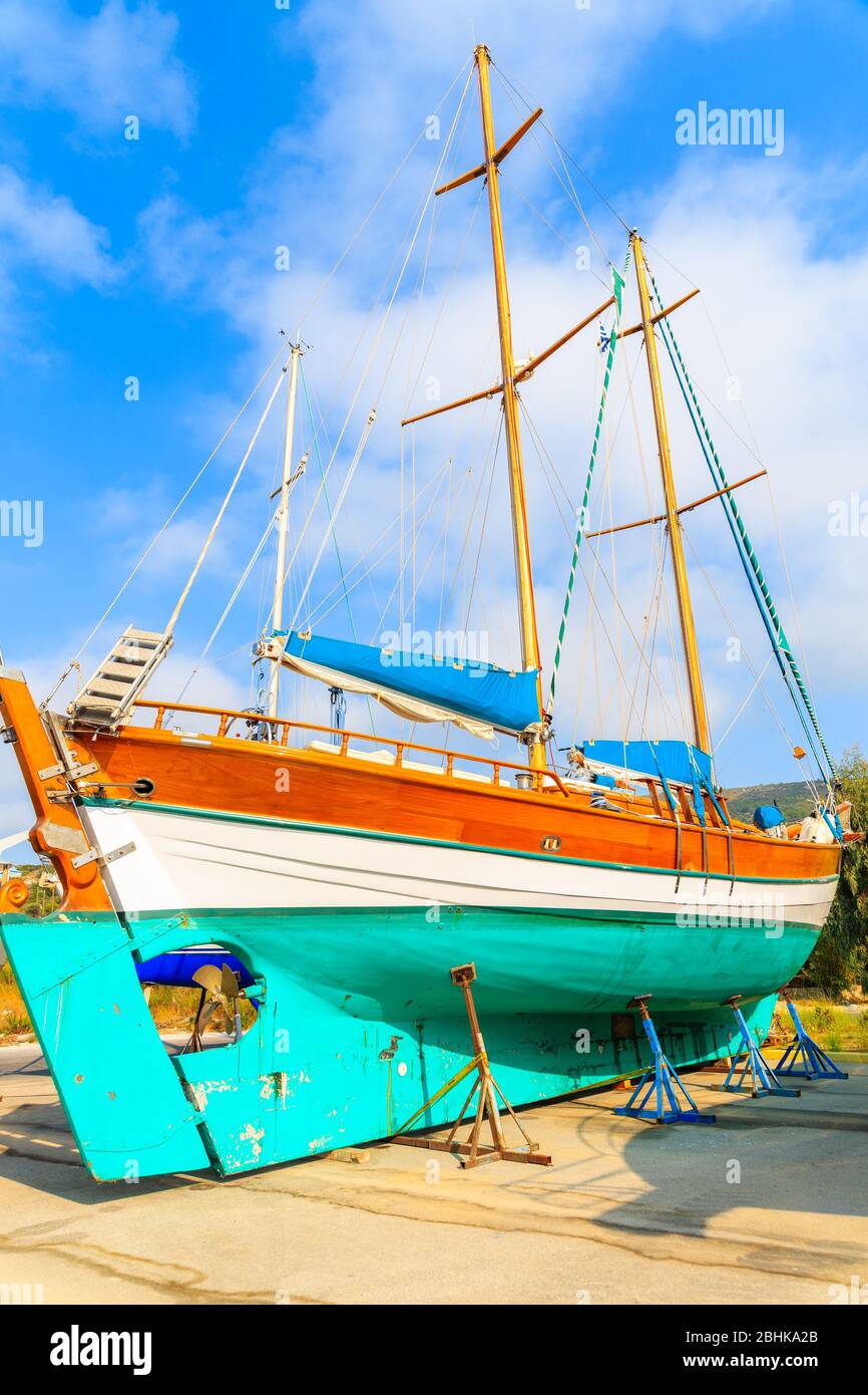 Traditional wooden sail boat in shipyard of small Greek marina, Samos island, Greece Stock Photo