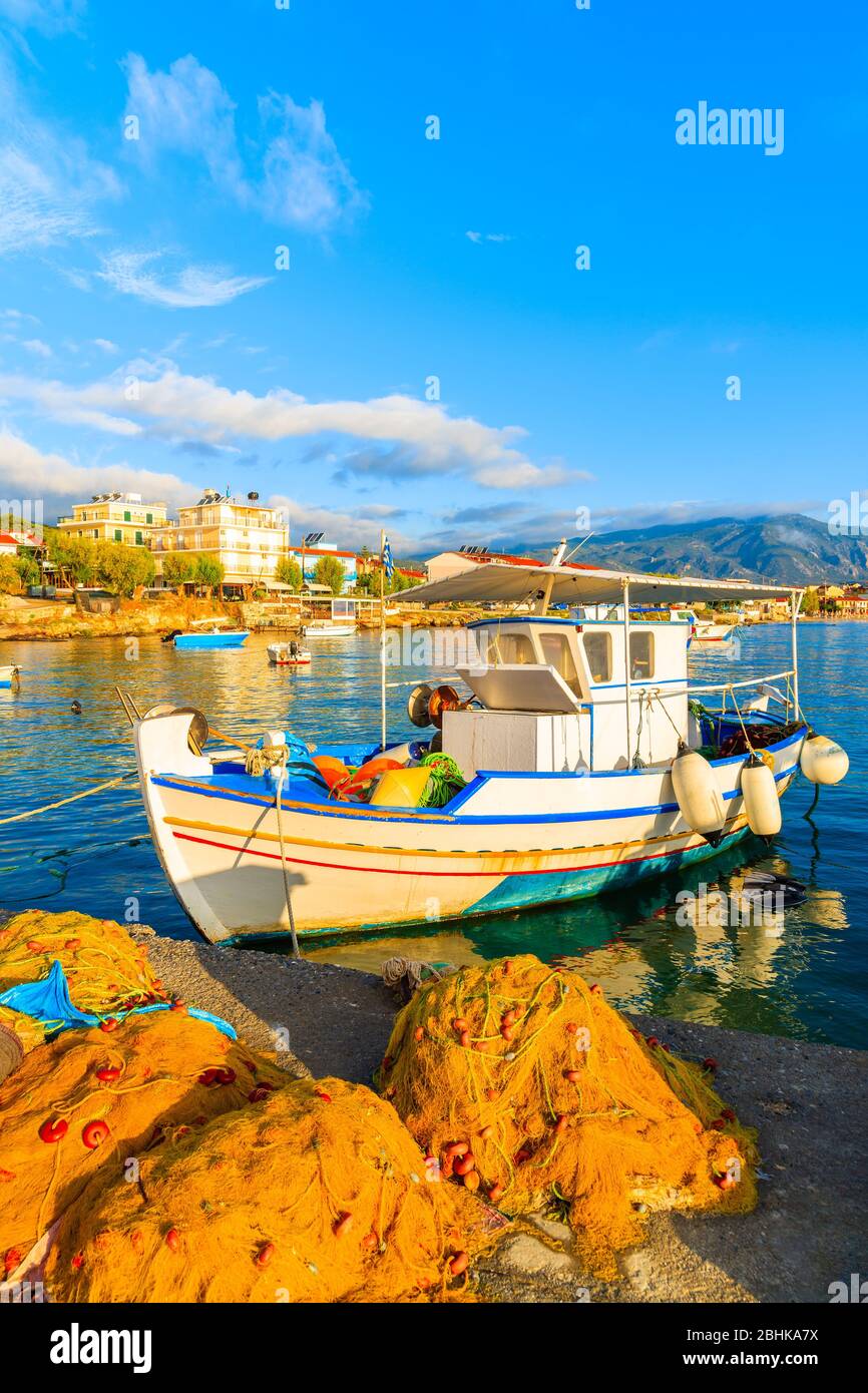 Traditional Greek fishing boat in port at sunrise on Samos island, Aegean Sea, Greece Stock Photo