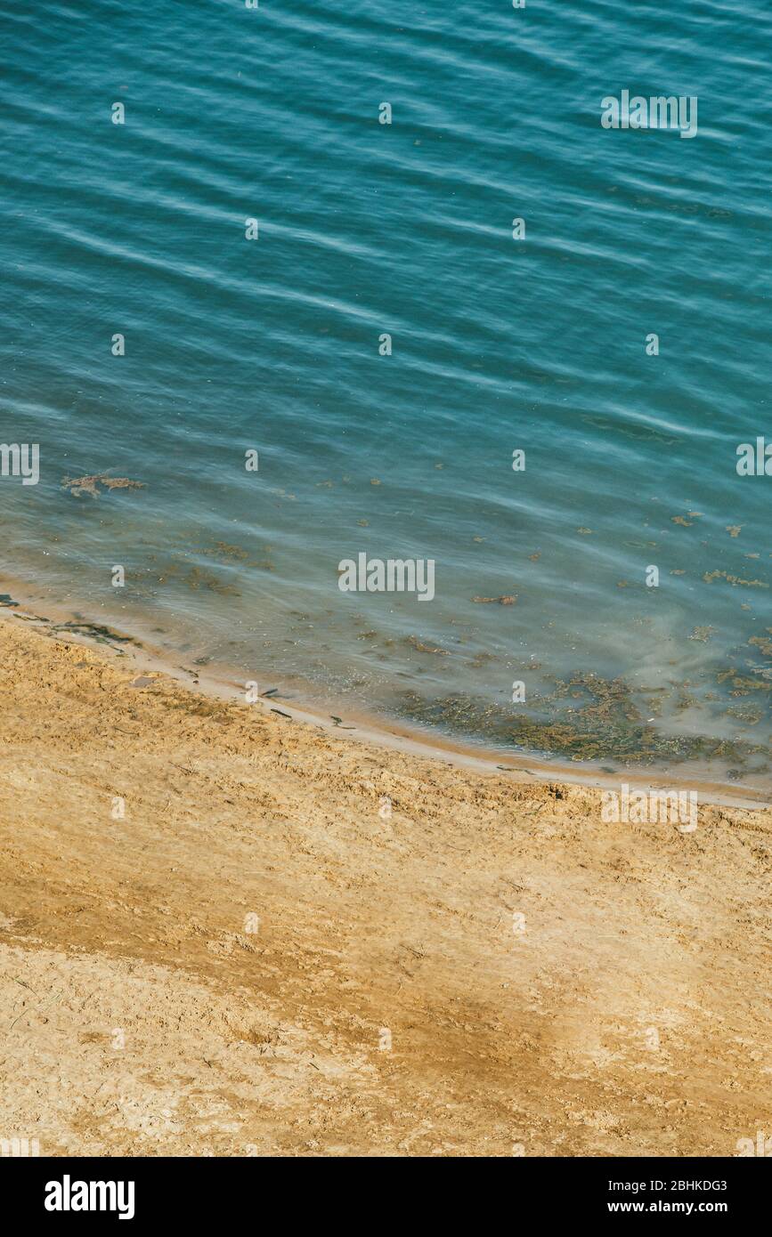 The expanse of the sea meets the sandy beach. Aerial view from quad copter Stock Photo