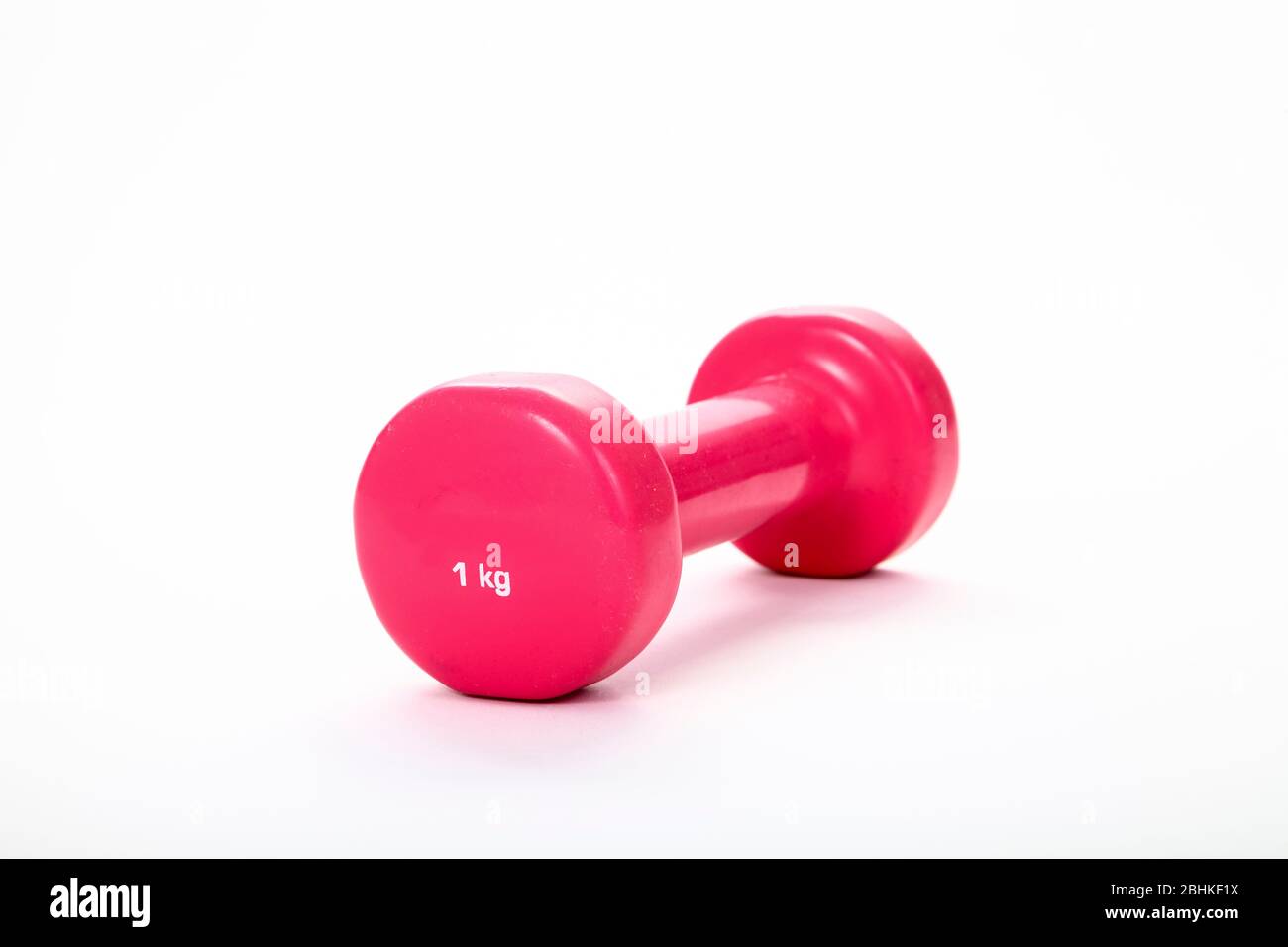 Pink 1KG dumbbell isolated on a white background Stock Photo