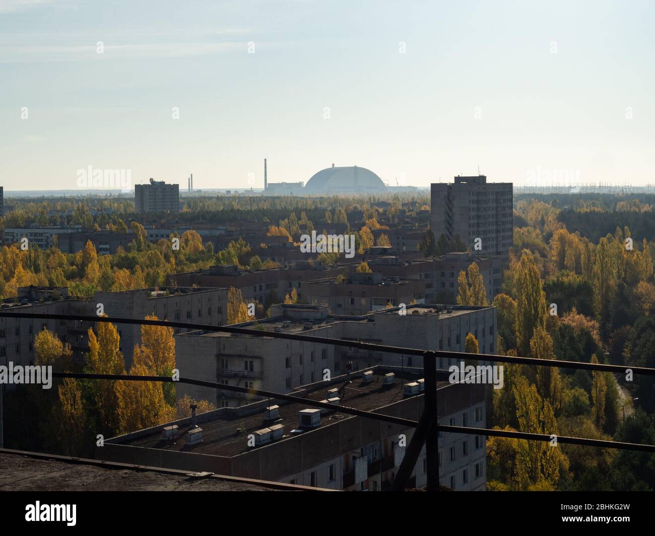 View from roof of ghost town Pripyat, post apocalyptic city and new sarcophagus of Chernobyl nuclear plant autumn season in Chernobyl exclusion zone, Stock Photo