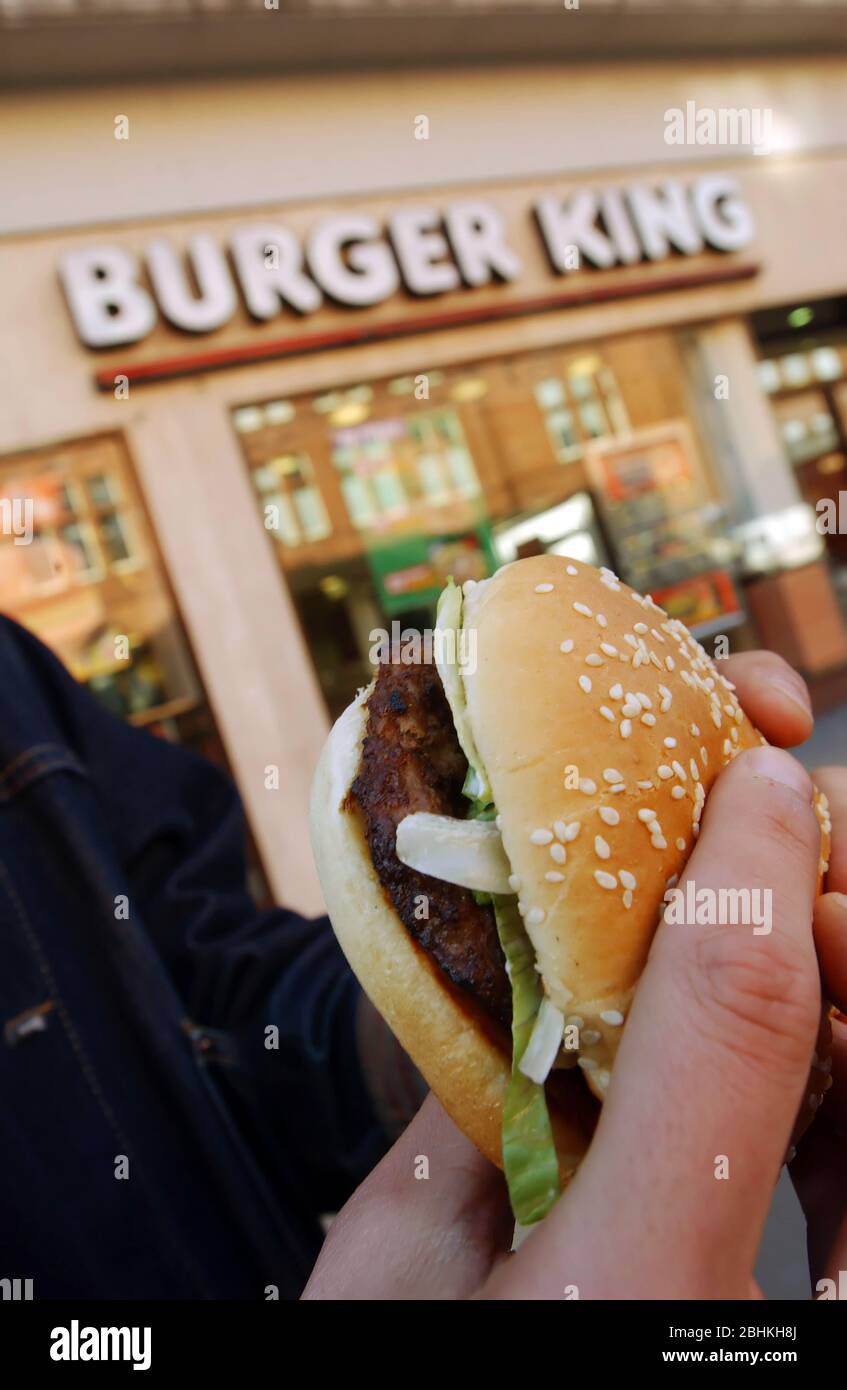 A Burger King customer eating his burger Stock Photo Alamy