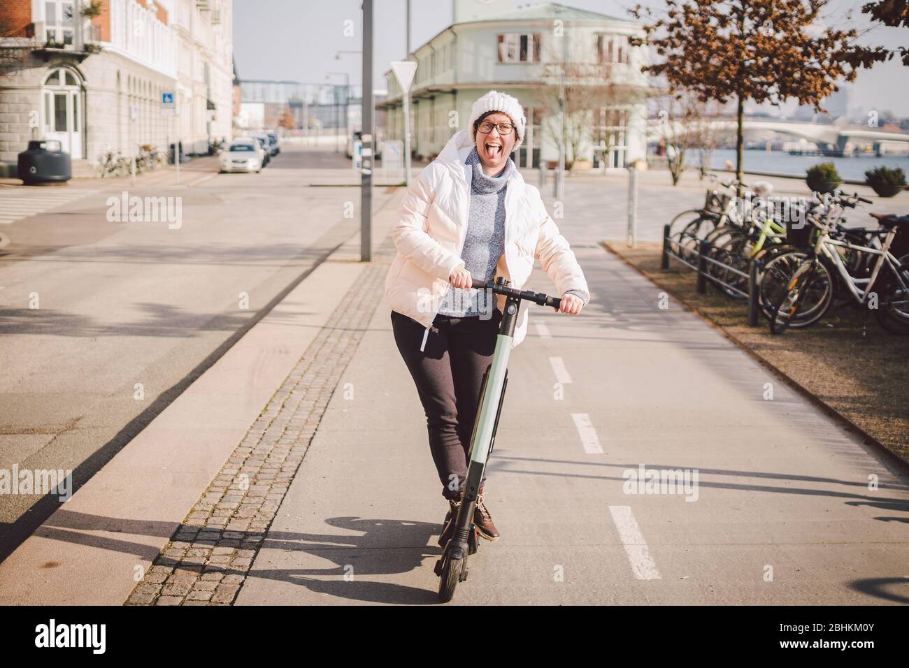 Young woman riding an electric scooter on bike path in copenhagen, modern  girl, new generation, electric transport in city, ecology and ecological  Stock Photo - Alamy
