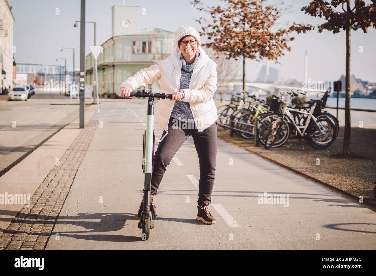 Tourist woman rent Electric scooter in danish capital Copenhagen. Female  holding steering column knob with electric kick scooter handle on street in  Stock Photo - Alamy
