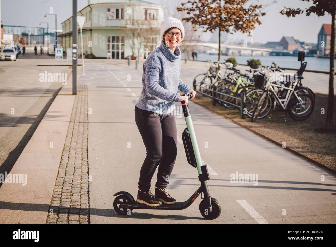 diagram dissipation Ekstrem Tourist woman rent Electric scooter in danish capital Copenhagen. Female  holding steering column knob with electric kick scooter handle on street in  Stock Photo - Alamy