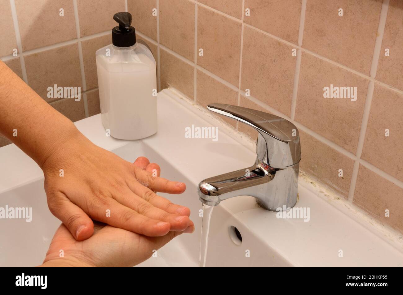 Female Doctor Using A Fully Sanitized Hospital Sink There Is Only One Jar To Disinfect By Washing Your Hands In An Effective And Proper Way To Avoid C Stock Photo
