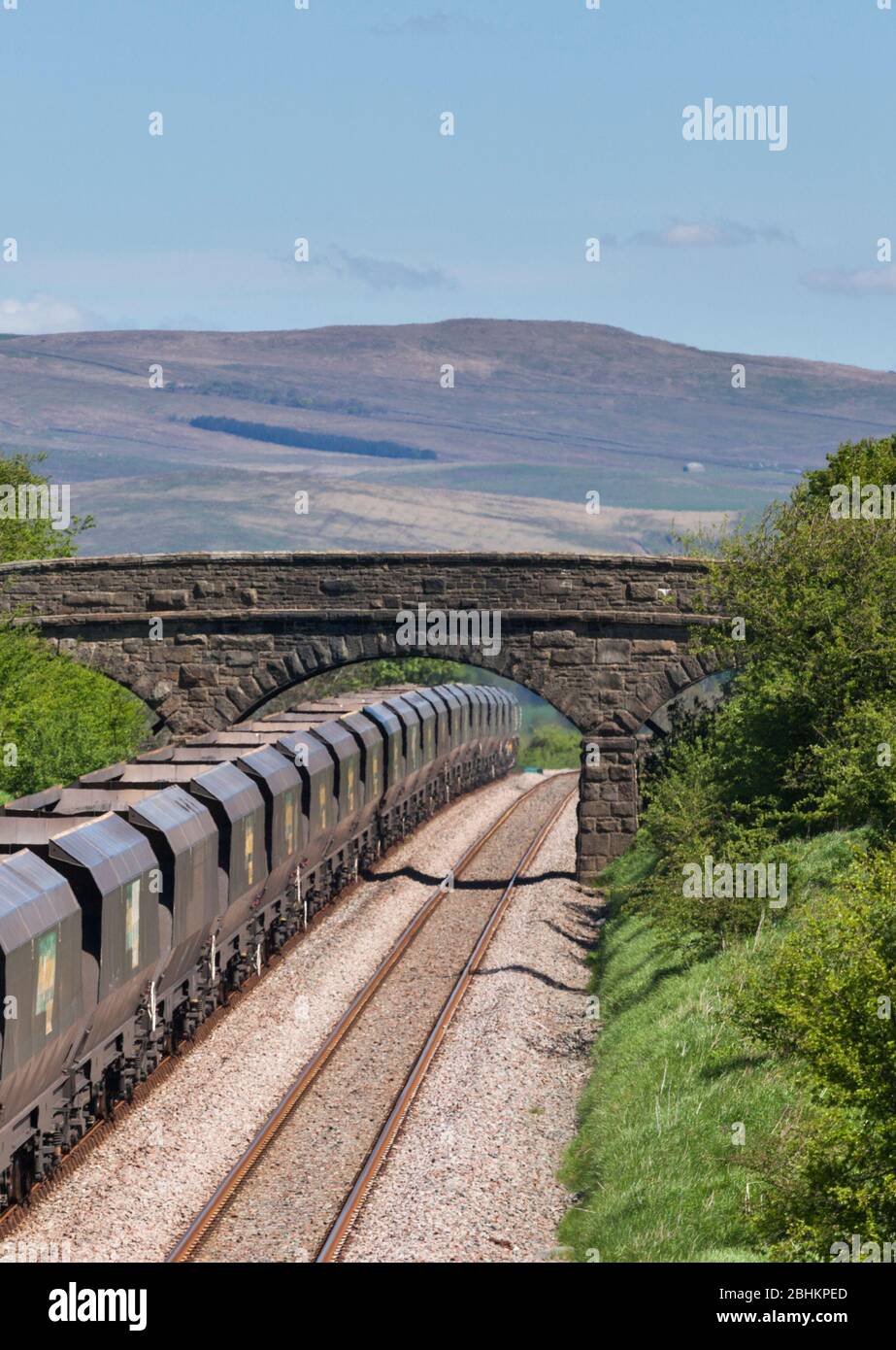 Freightliner 'Merry go round' coal freight train cresting the summit on the railway line at Paythorne, on the Blackburn to Hellifiled railway Stock Photo