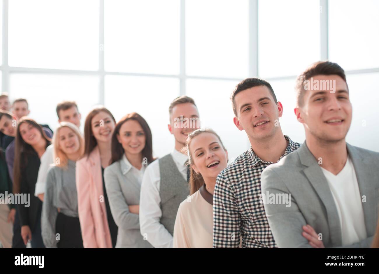 group of smiling young professionals standing in a row Stock Photo - Alamy