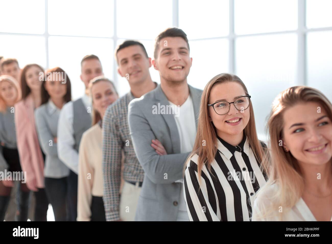 group of smiling young professionals standing in a row Stock Photo - Alamy