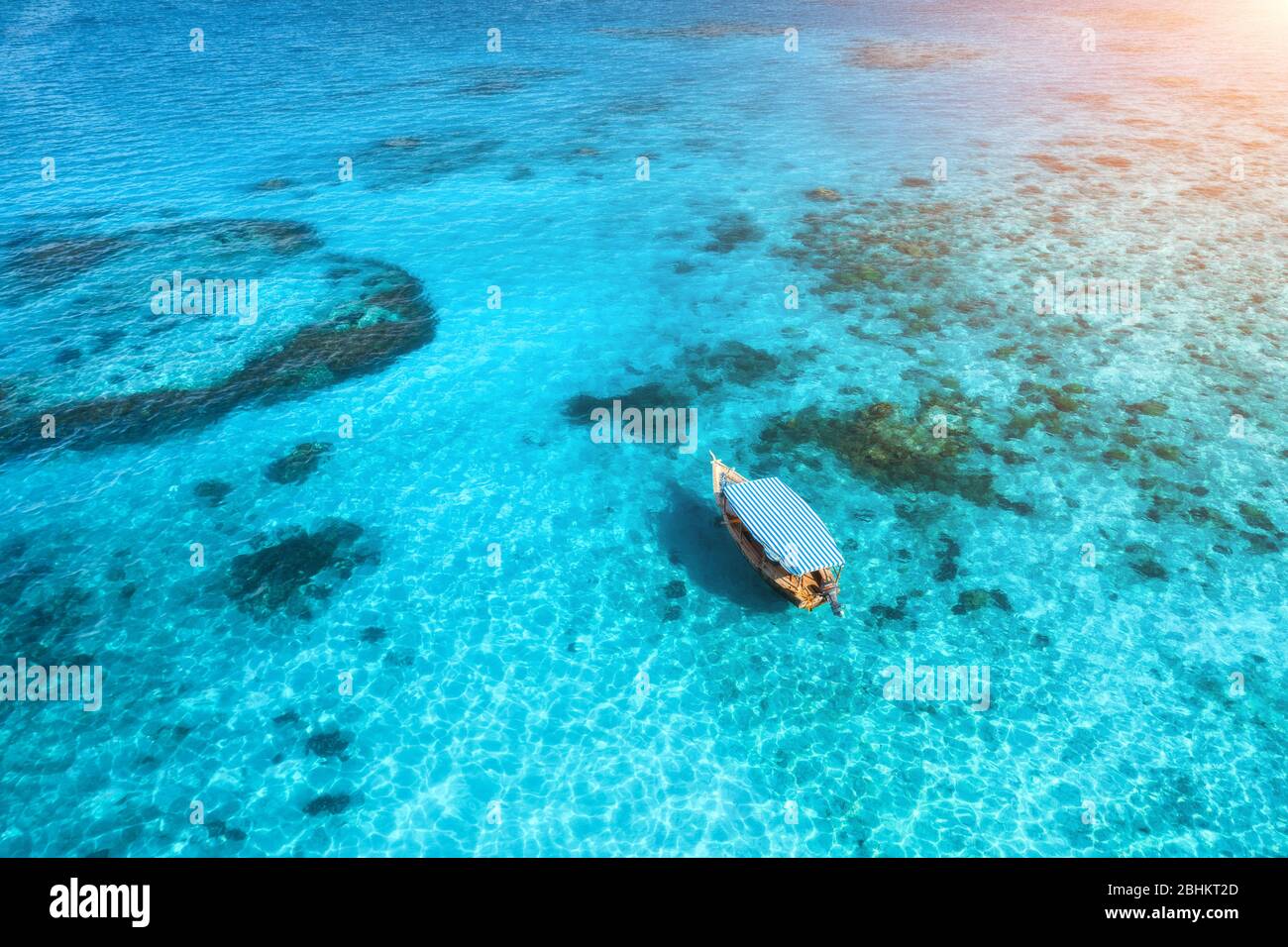 Aerial view of the white boat in the clear blue water at sunset Stock ...