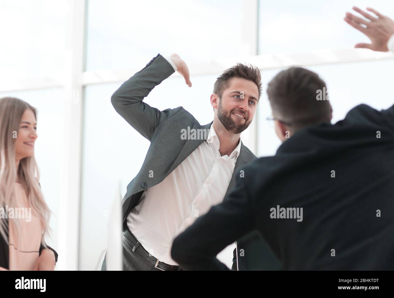 happy employees giving each other a high five Stock Photo - Alamy