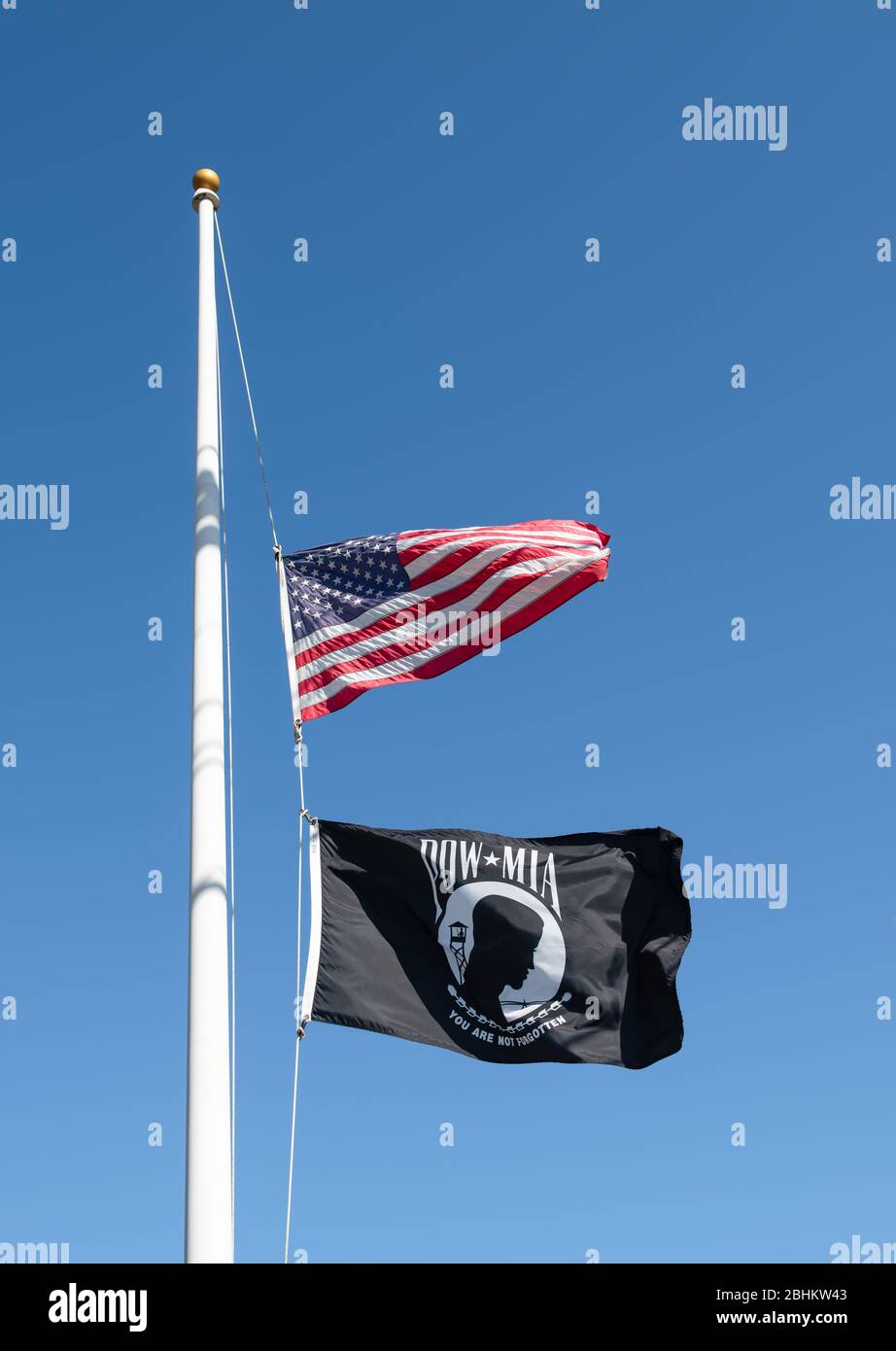 POW MIA and American flag, both on same flag pole at half mast. Stock Photo