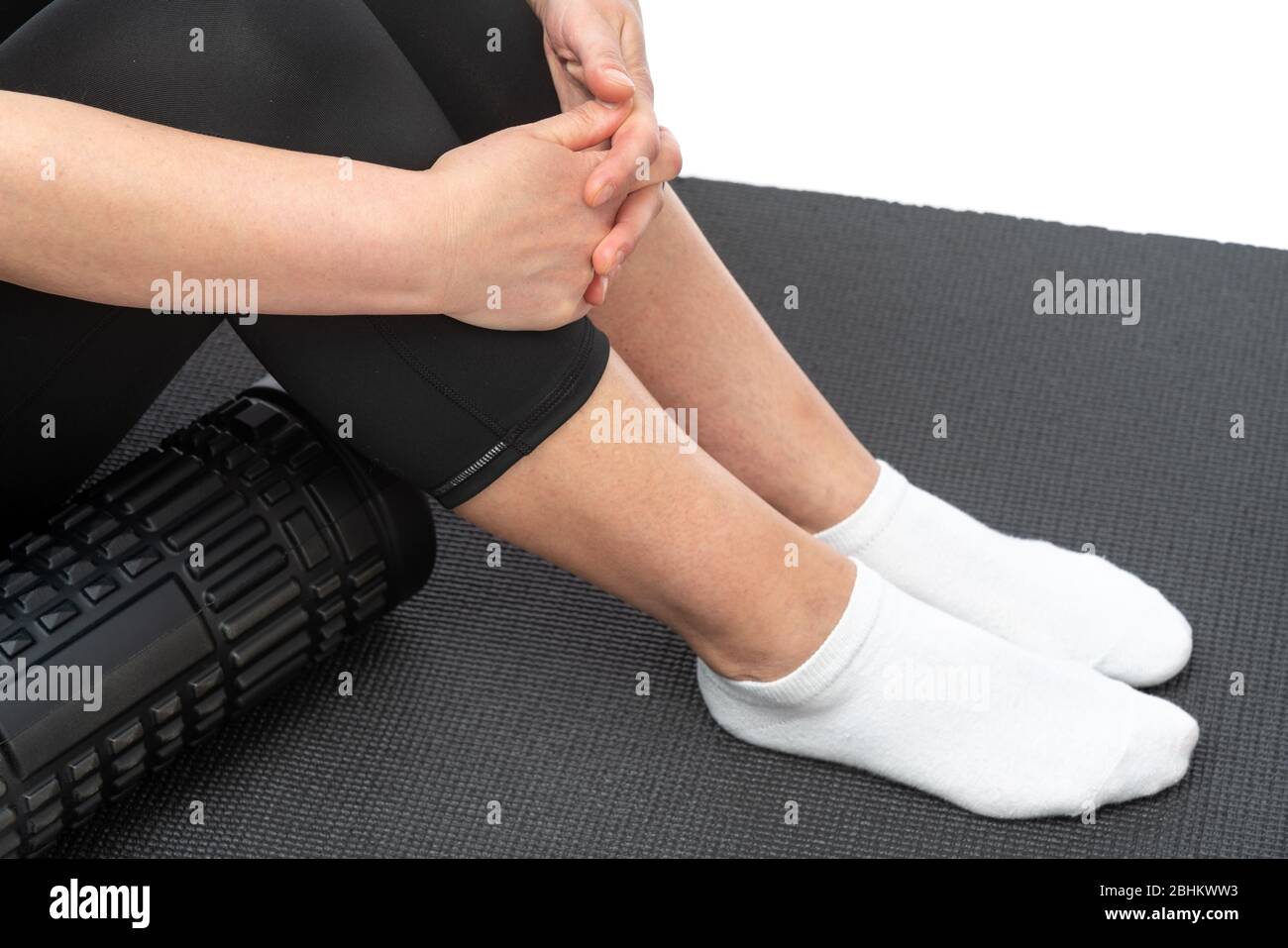 A middle-aged woman on a myofascial roller prepared to do cellulite massage Stock Photo