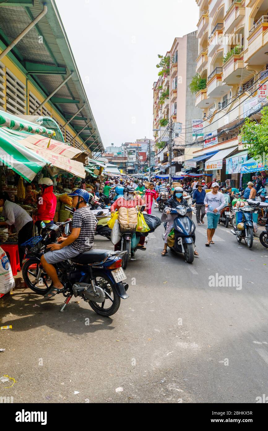 Crowded street with motorcycles in busy Binh Tay OR Hoa Binh Market, Chinatown (Cholon), District 5, Saigon (Ho Chi Minh City), south Vietnam Stock Photo