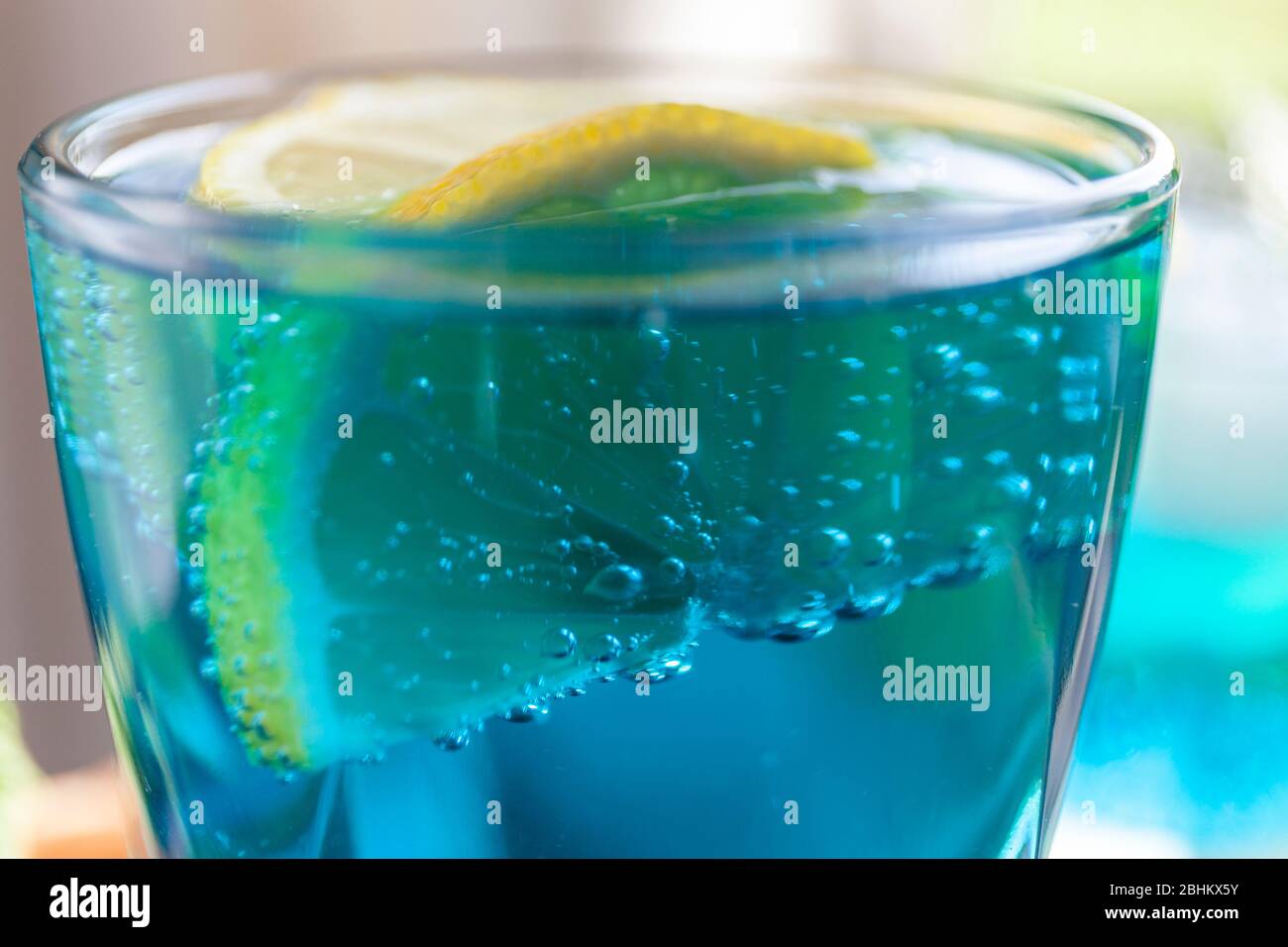Blue lagoon cocktail. Lemon soda water in a glass, close up. Refreshing