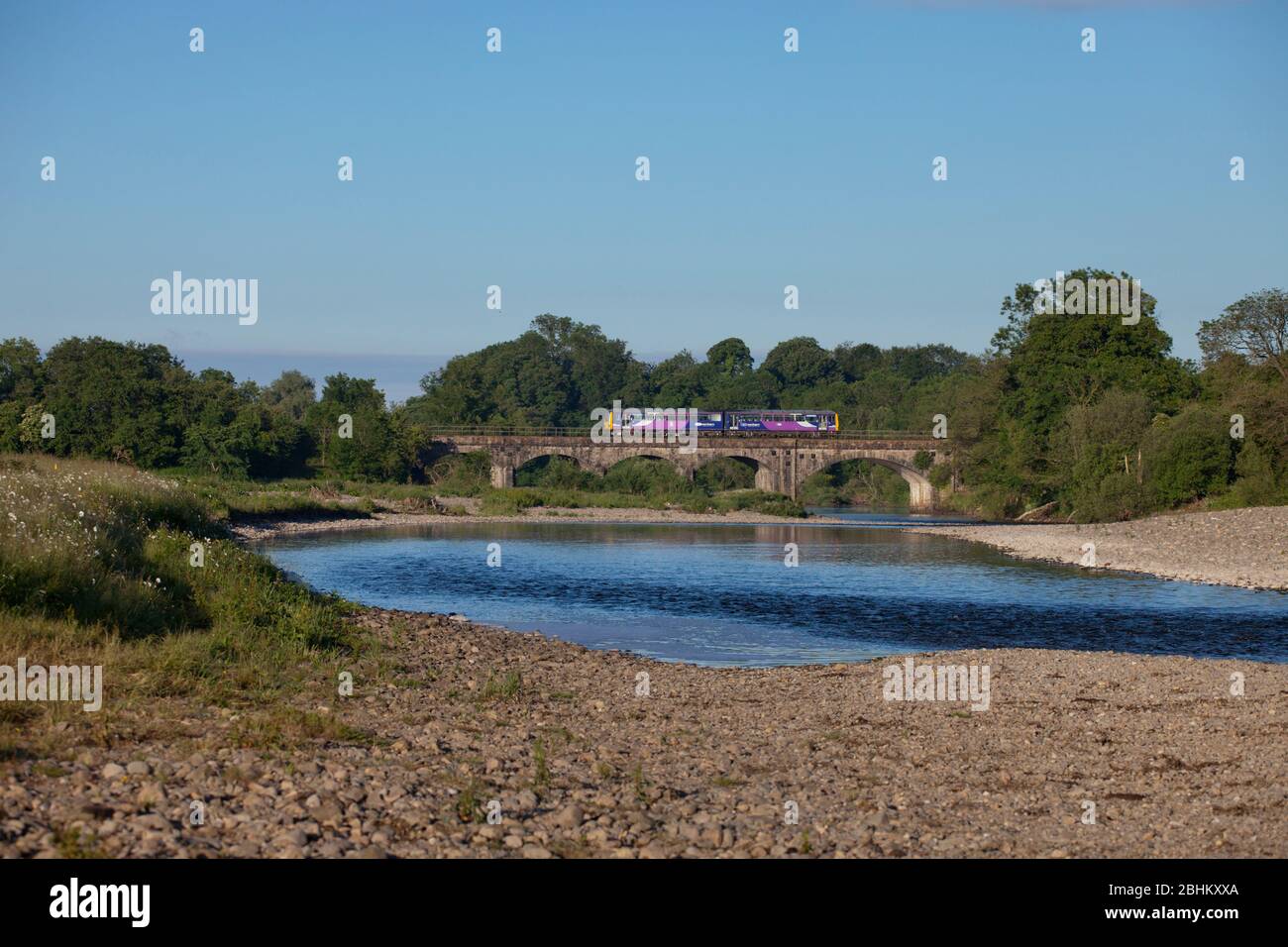 Northern Rail class 144 pacer train crossing the river lune  viaduct at Arkholme on the scenic 'little north western' railway line in Lancashire Stock Photo