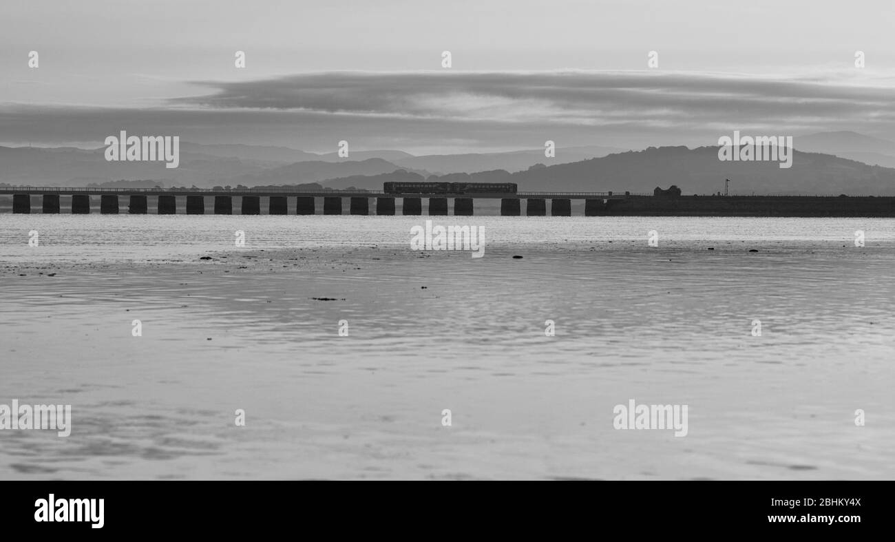 2 Northern rail class 153 sprinter trains crossing The river Kent viaduct at Arnside on the scenic Cumbrian coast railway with the tide up Stock Photo