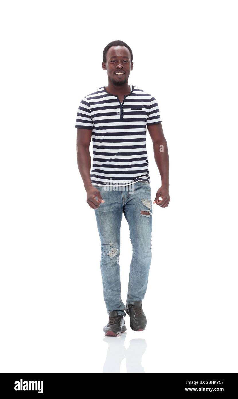 stylish young man confidently stepping forward . isolated on white Stock Photo