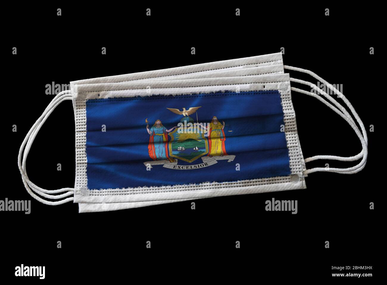 Multiple surgical face masks with New York state flag printed. Isolated on black background. Concept of face mask usage in New Yorkers effort to comba Stock Photo