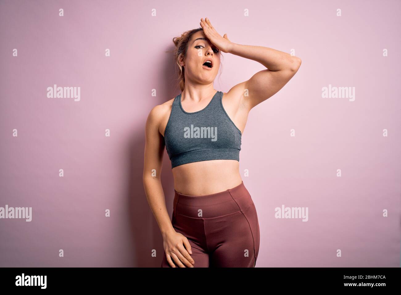 Young beautiful blonde sportswoman doing sport wearing sportswear over