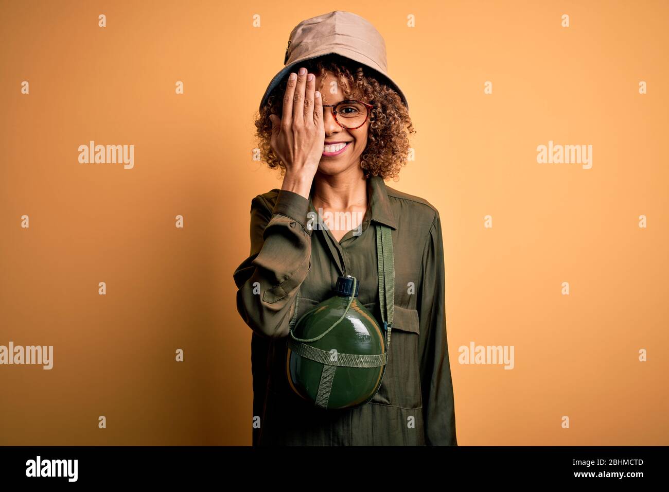 Young african american tourist woman on vacation wearing explorer hat ...