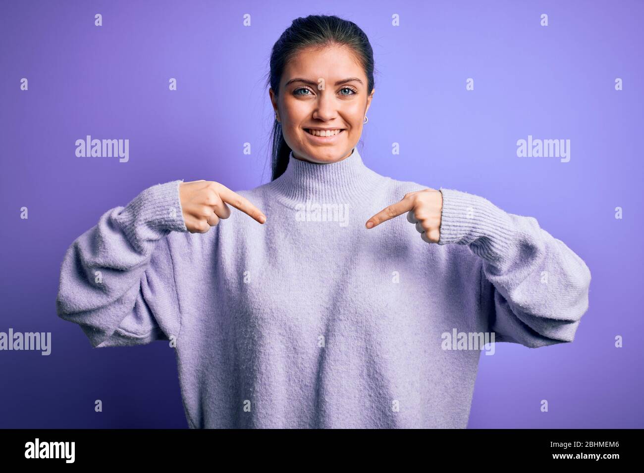 Young beautiful woman with blue eyes wearing casual turtleneck sweater ...