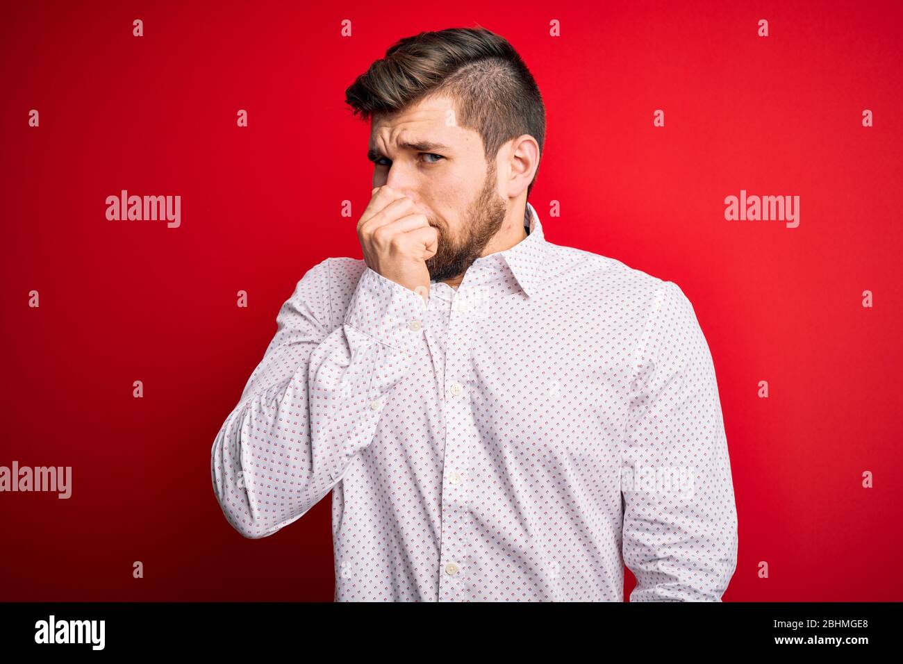 Young blond businessman with beard and blue eyes wearing elegant shirt ...