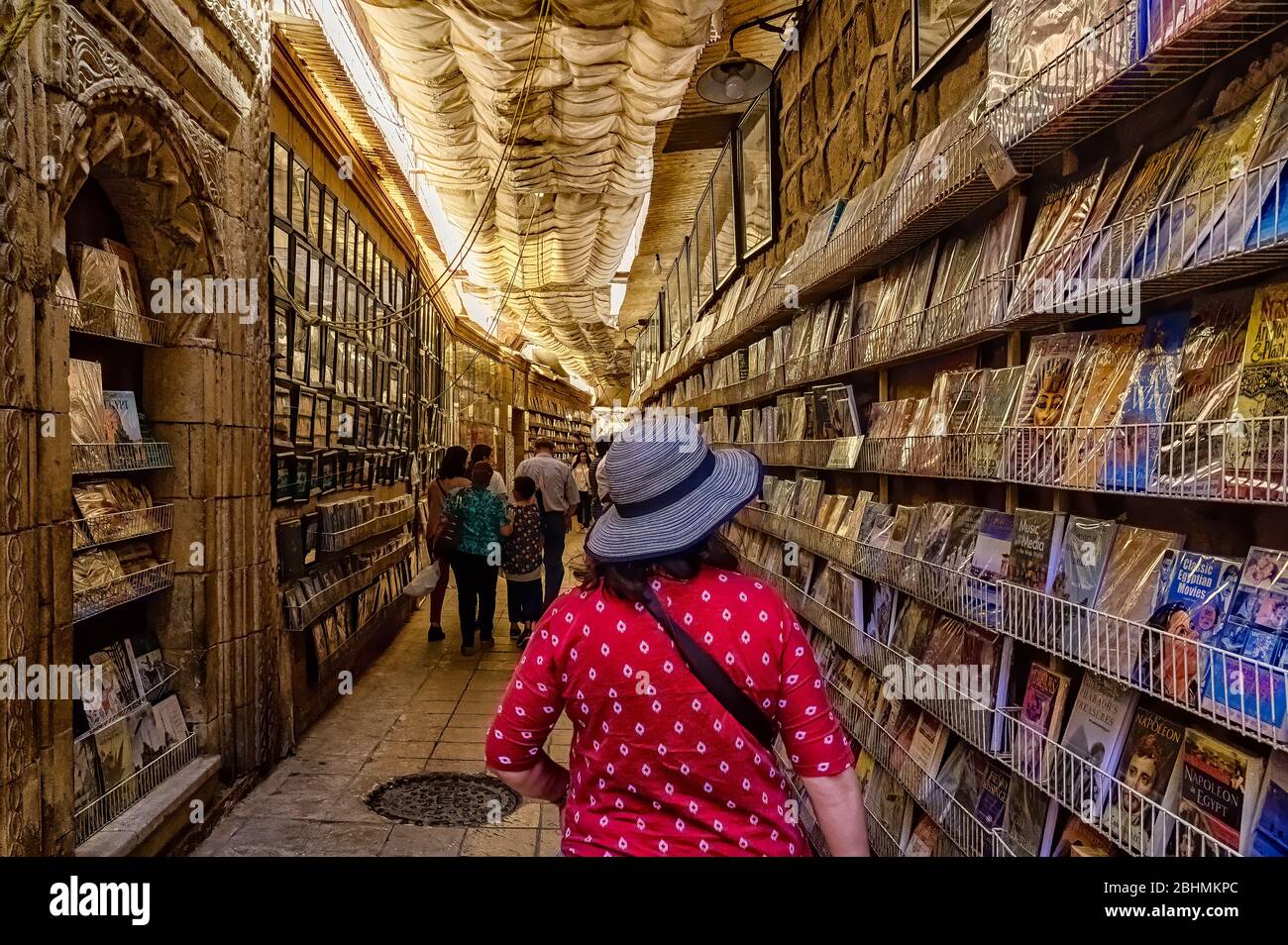 Walking through the open air Bookstore in the corridor leading to the Hanging Church Stock Photo