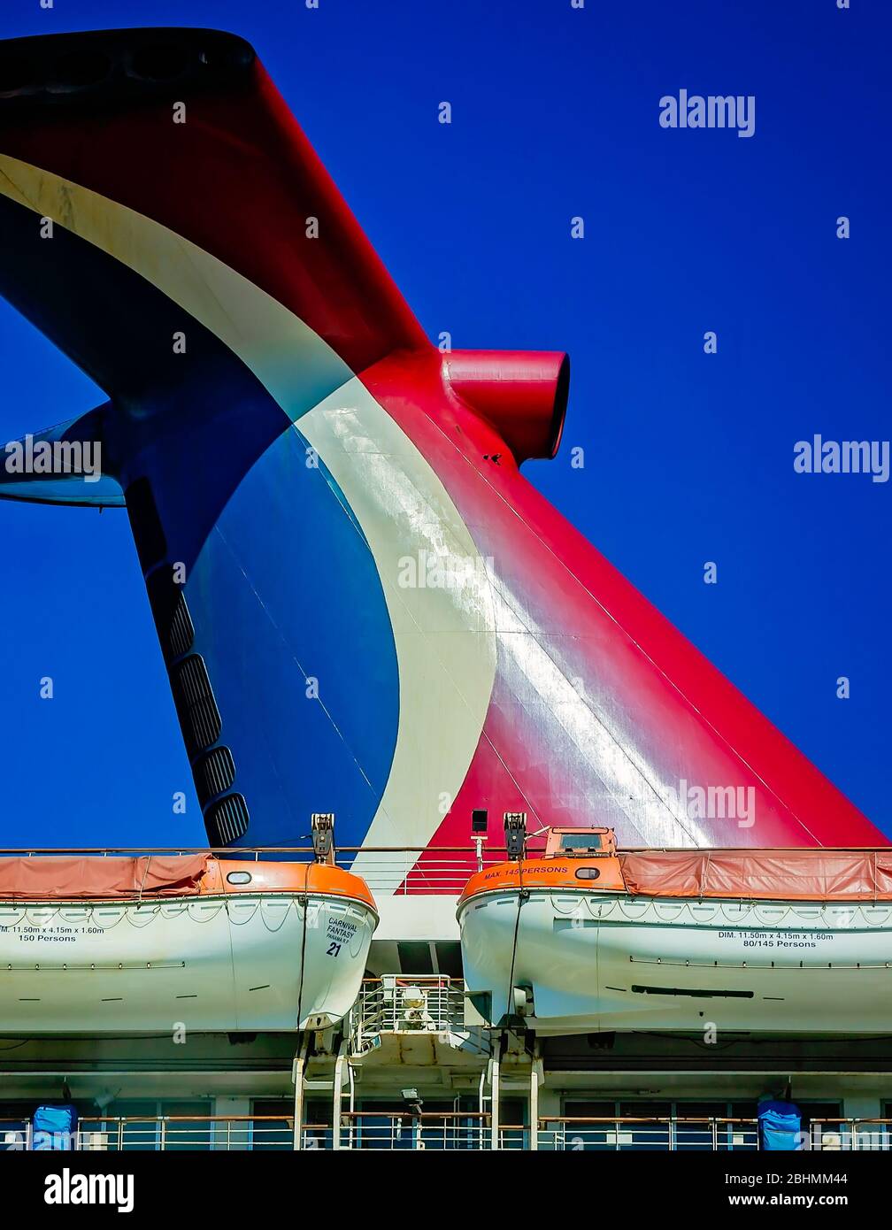 The Carnival Fantasy cruise ship’s whale tail funnel and lifeboats are pictured at the Alabama Cruise Terminal,  April 24, 2020, in Mobile, Alabama. Stock Photo