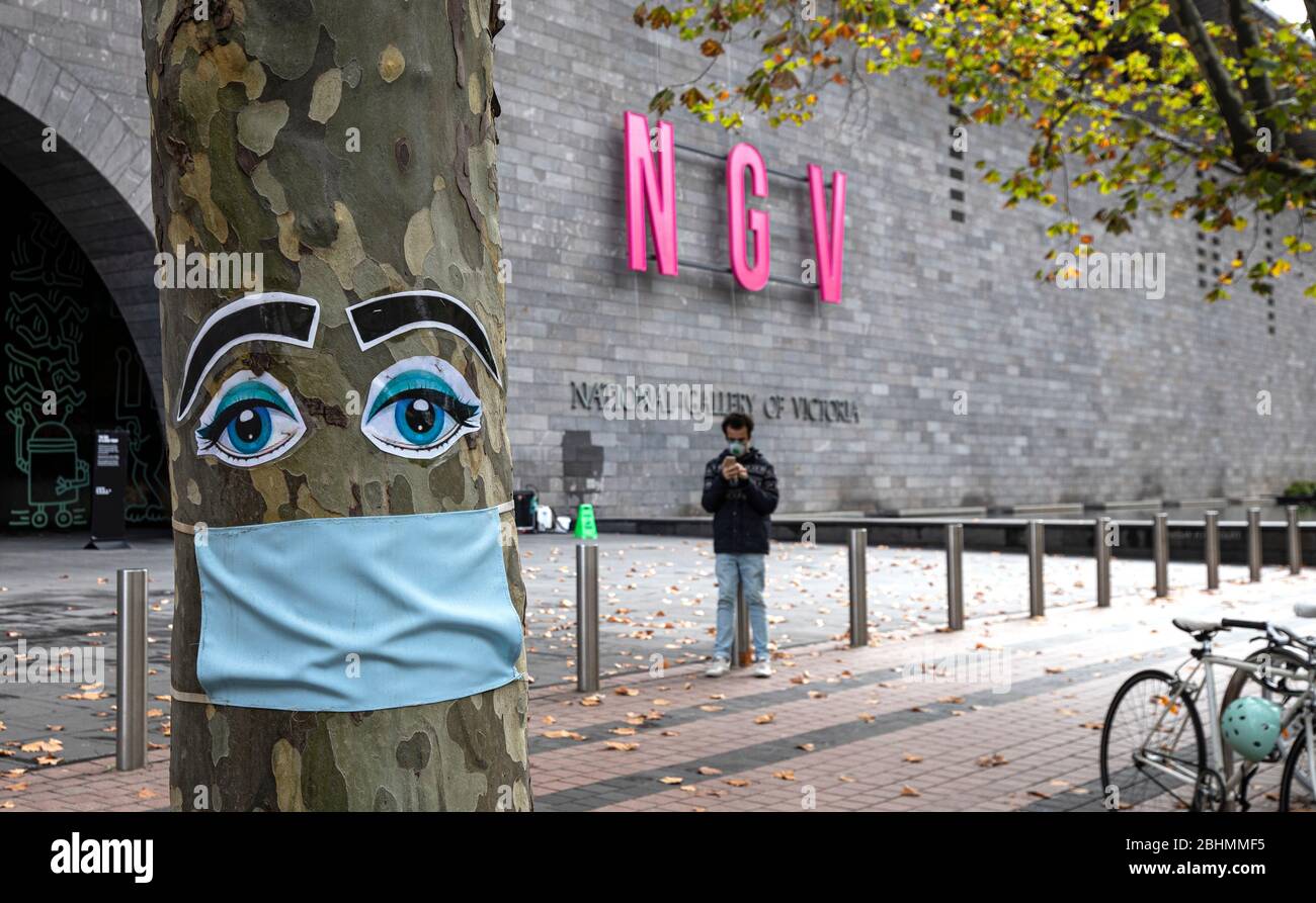 Covid-19 Pandemic Melbourne Australia 2020. Surgical face mask on a tree outside the National Gallery of Victoria in Melbourne. Stock Photo