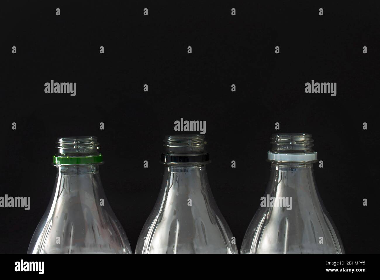 A Close up of empty plastic soft drink bottles on a black background Stock Photo