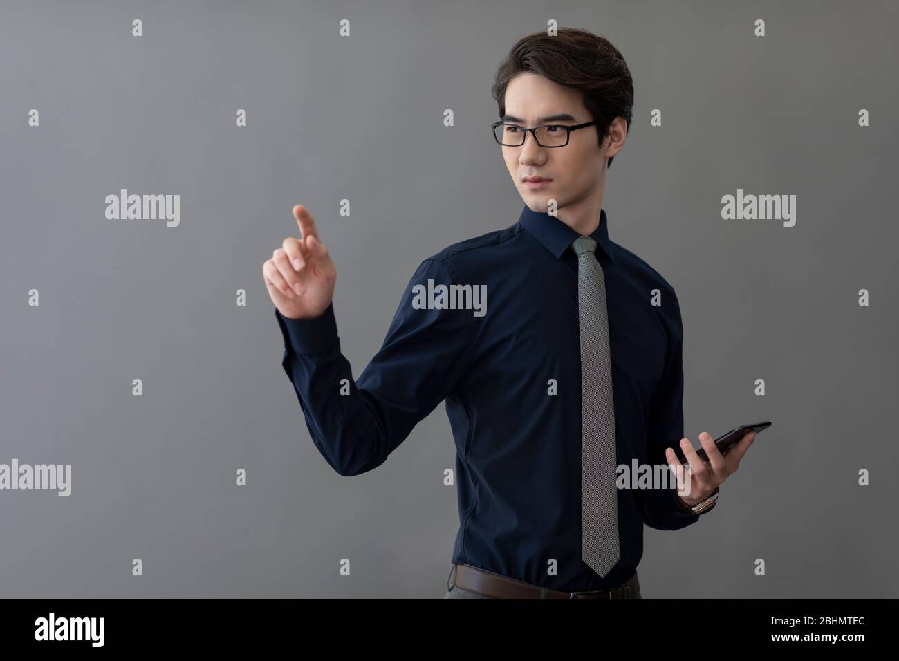 Young Chinese businessman using advanced touch screen technology Stock Photo