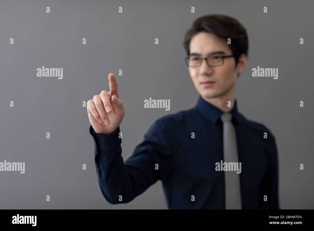 Young Chinese businessman using advanced touch screen technology Stock Photo