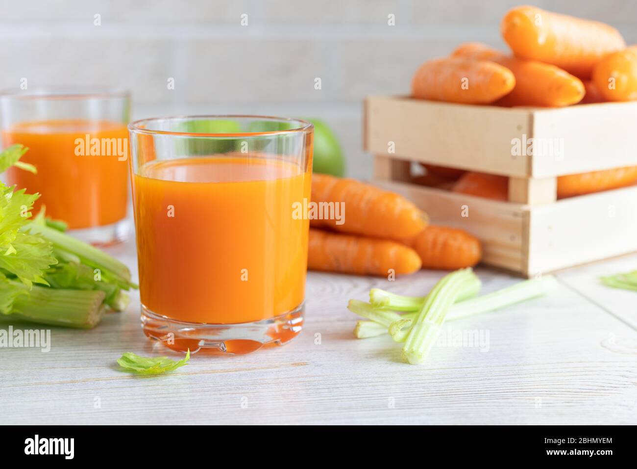 Carrot juice and green celery on the table. Diet, healthy eating, food