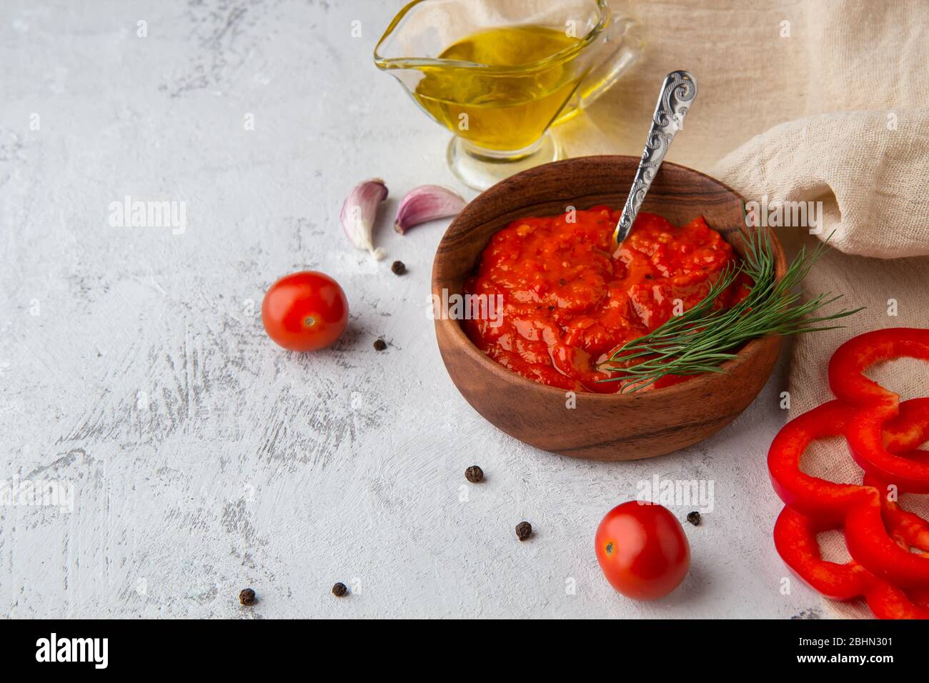 Balkan snack ajvar, lutenitza, pingjur with ingredients on a light background. Place for text Stock Photo
