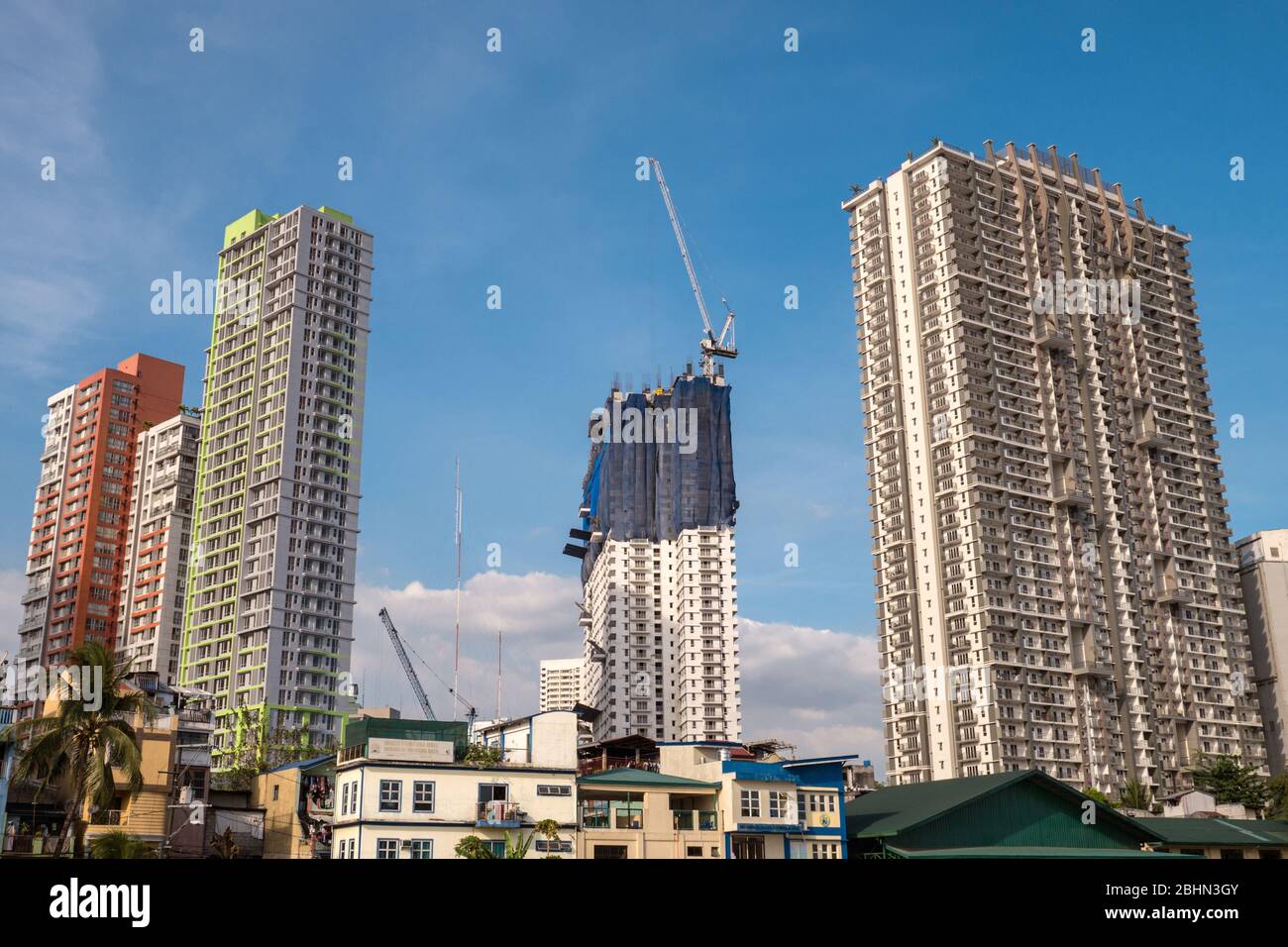 Manila, Philippines - March 15, 2018: Cityscape of skyscrapers in business district of Mandaluyong, blue sky Stock Photo