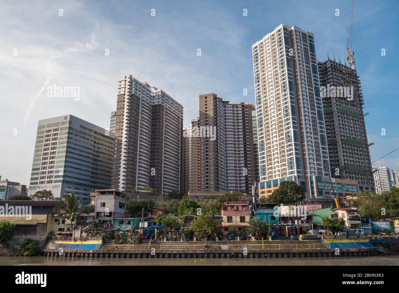 Manila, Philippines - March 15, 2018: Cityscape of skyscrapers in business district of Mandaluyong, blue sky Stock Photo