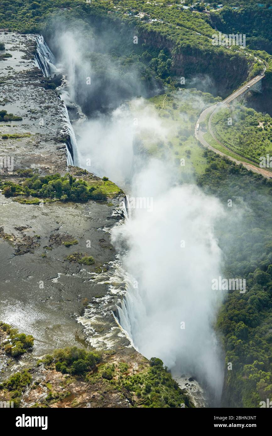 Victoria Falls or 'Mosi-oa-Tunya' (The Smoke that Thunders), and Zambezi River, Zimbabwe / Zambia border, Southern Africa - aerial Stock Photo