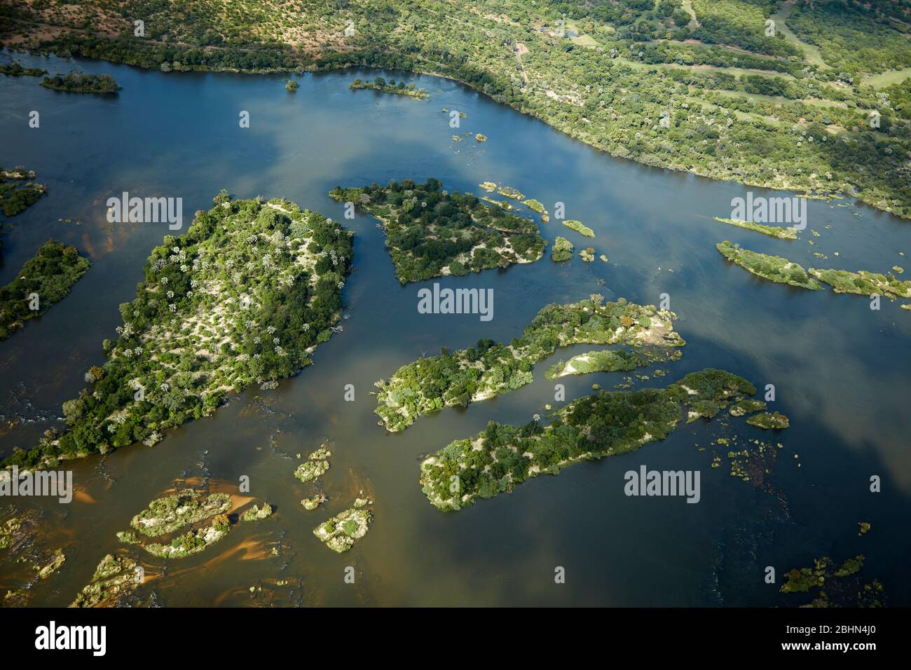 Islands in Zambezi River, just above Victoria Falls, Zimbabwe / Zambia border, Southern Africa - aerial Stock Photo
