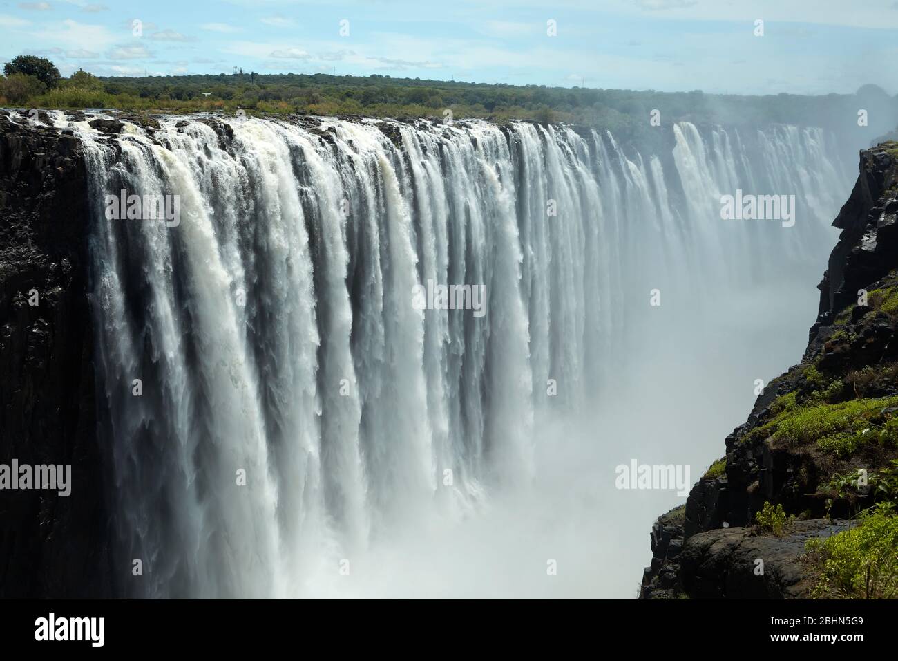 Victoria Falls or "Mosi-oa-Tunya" (The Smoke that Thunders), and Zambezi River, Zimbabwe / Zambia border, Southern Africa Stock Photo